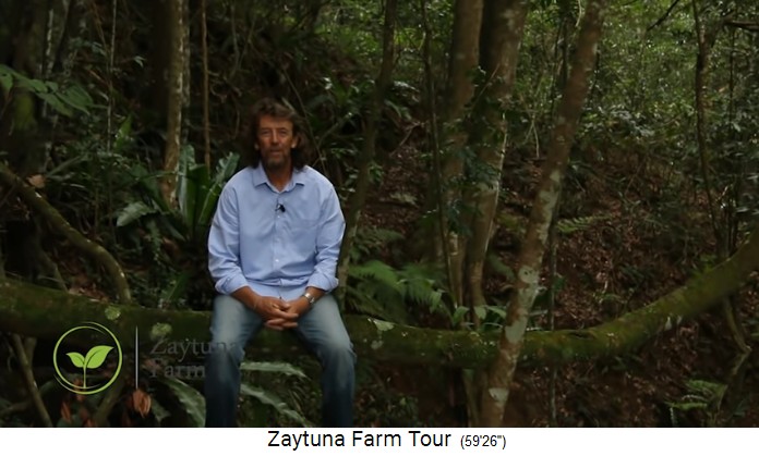 Zaytuna-Farm
                    (Australien), Geoff Lawton sitting on a trunk in the
                    forest
