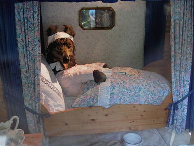 Fairy tale forest in
                              Ibbenbueren 02, a wolf in a bed (fairy
                              tale: Red Riding Hood)