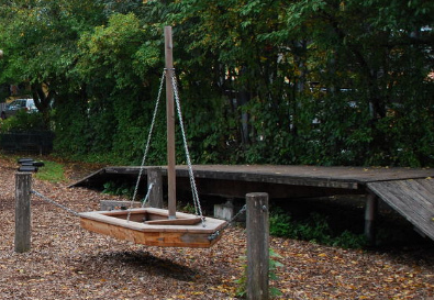 Little swing boat on the playground of
                            Frasdorf, Bavaria, Germany