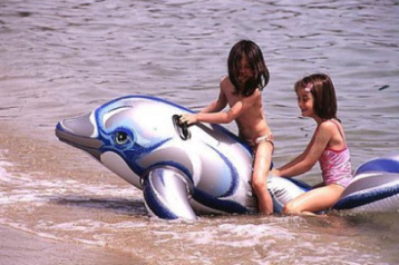 Water plays 08,
                              children on a rubber dolphin